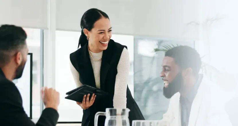 Business analyst smiling with team during weekly meeting